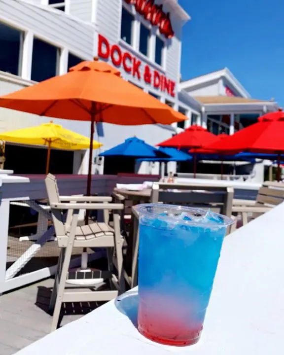 A drink is sitting on the table outside of dock & dine.
