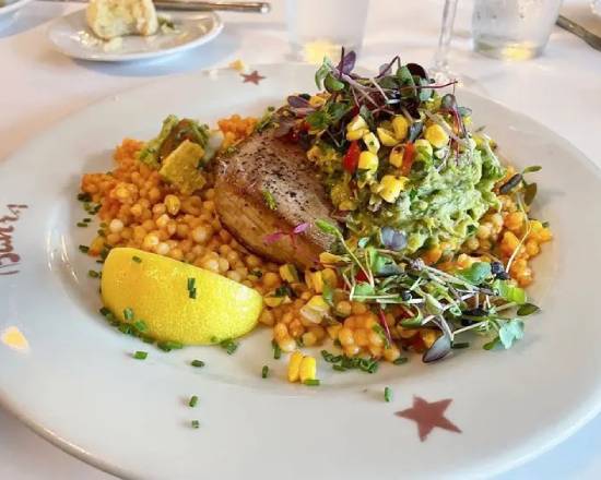 A plate of food on top of corn and other foods.
