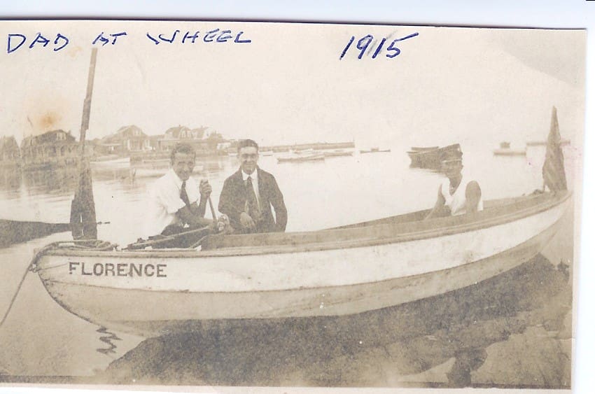 A couple of men in a boat on the water.